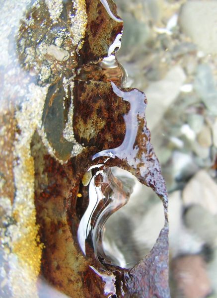 PL_Beach river through rusting rivet hole DSCF3019